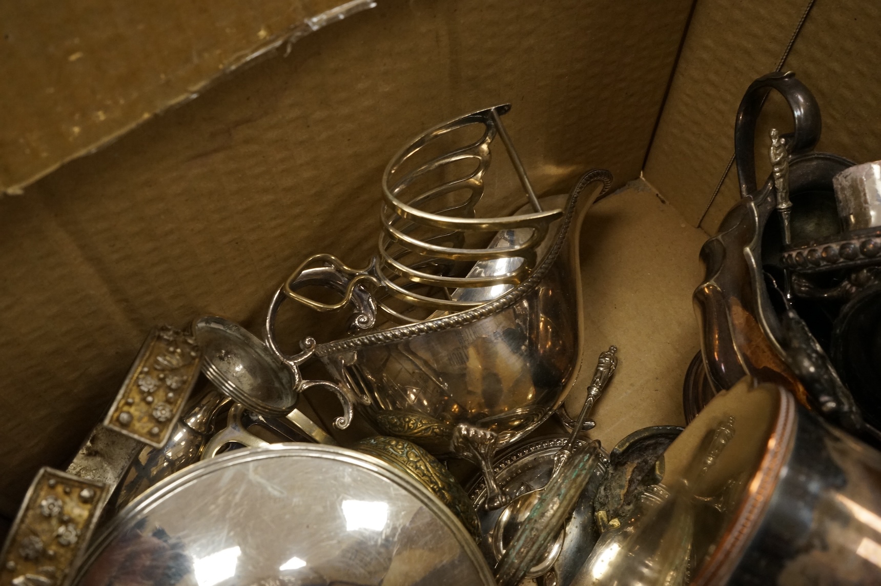 A quantity of assorted plated wares, including flatware, a tea caddy, a chatelaine, a toast rack, a sauceboat, a butter dish and a pair of candlesticks, etc.
